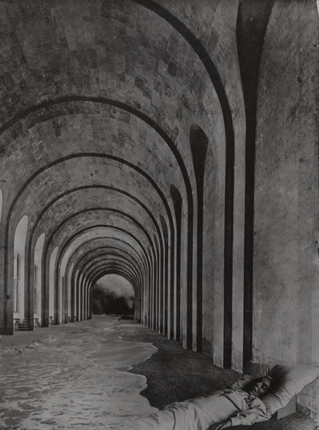 A receding corridor of stone arches