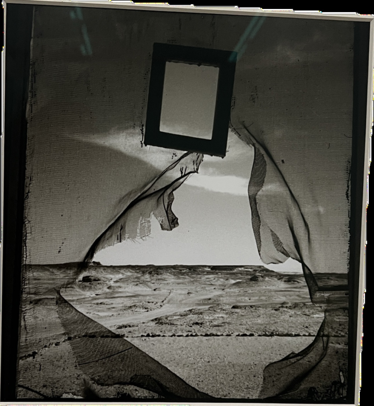 Collage of an empty frame over a stormy sea